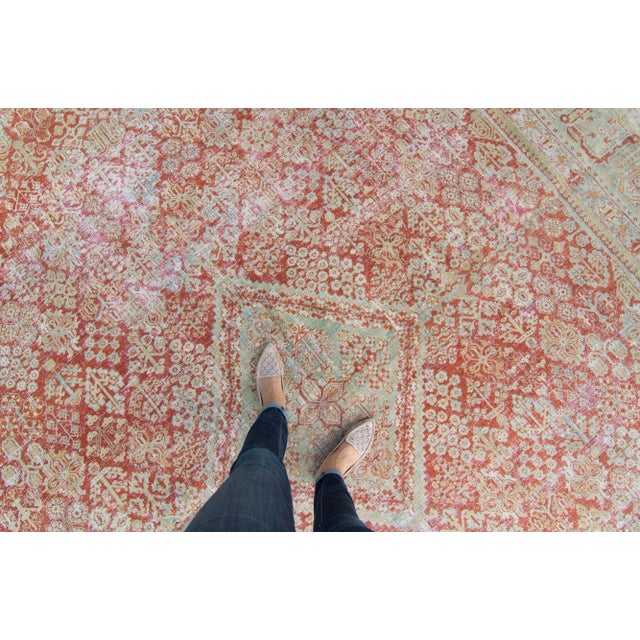 A large elegant hand-knotted rug with a sage base color throughout. This piece highlights a central medallion adorned and...