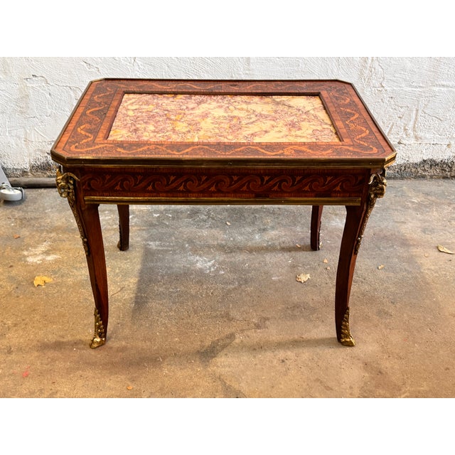 This Louis XV Revival side table is a masterful example of late 19th to early 20th-century craftsmanship, capturing the...