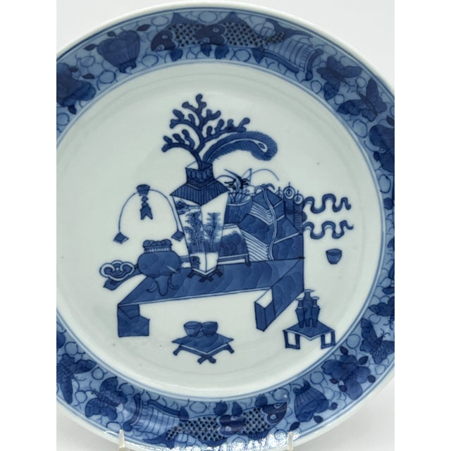 Chinese, circa 1780. Chinese export blue & white plate, painted with a ‘precious objects’, pattern, with scrolls, censors...