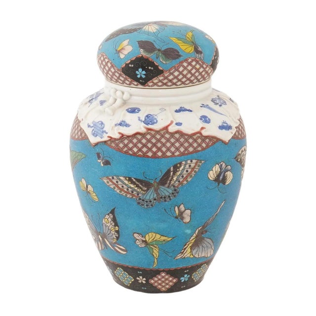 A finely decorated Japanese porcelain covered jar from the Meiji period, executed in tōtai shippo cloisonné enamel on...