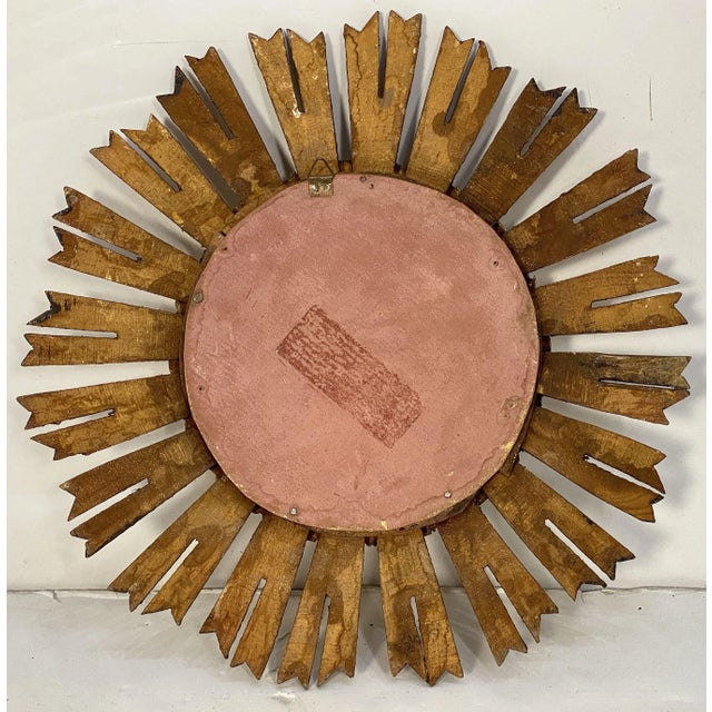 A fine French gilt starburst or sunburst mirror, featuring a beautifully carved bezel with a mass of gilded rays and the...