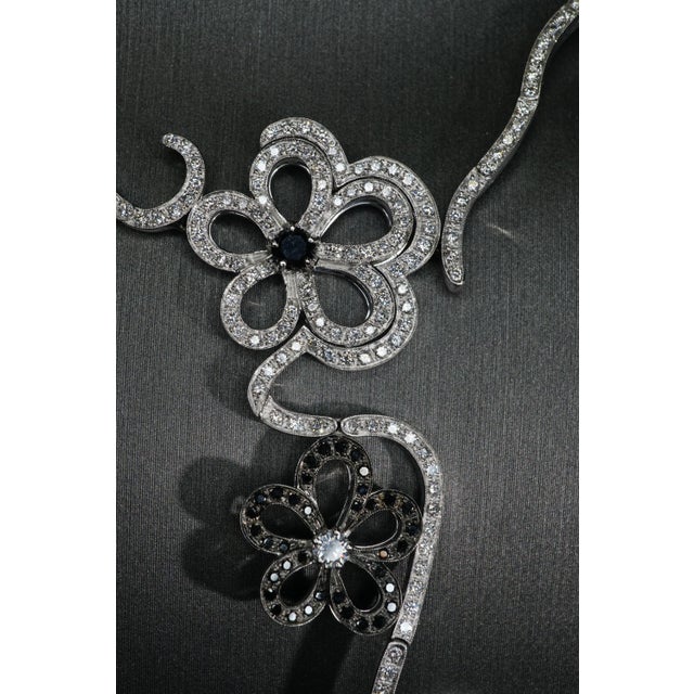 Unique Floral motif Pave set diamond necklace set in 18K White Gold with the following specifications; White diamonds:...