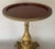 Offering an elegant vintage solid brass occasional table featuring a richly detailed neoclassical-inspired base with...