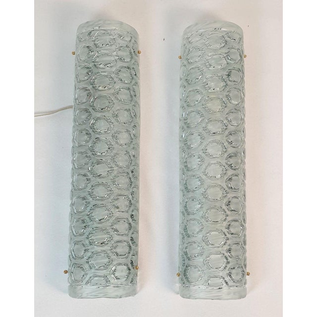 Pair of tall Mid Century Modern Murano glass wall sconces, attributed to Mazzega, Italy 1980s. The vintage sconces are...