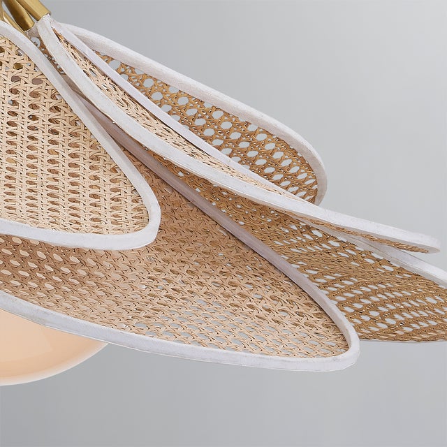 Petals of natural rattan caning are trimmed in white cotton and layered around an opal glossy glass globe to give Florina...