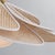 Petals of natural rattan caning are trimmed in white cotton and layered around an opal glossy glass globe to give Florina...