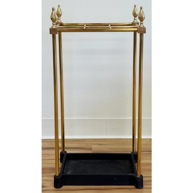 Early 20th C rectangular brass and cast iron umbrella stand. This classic English style piece has a traditional brass...