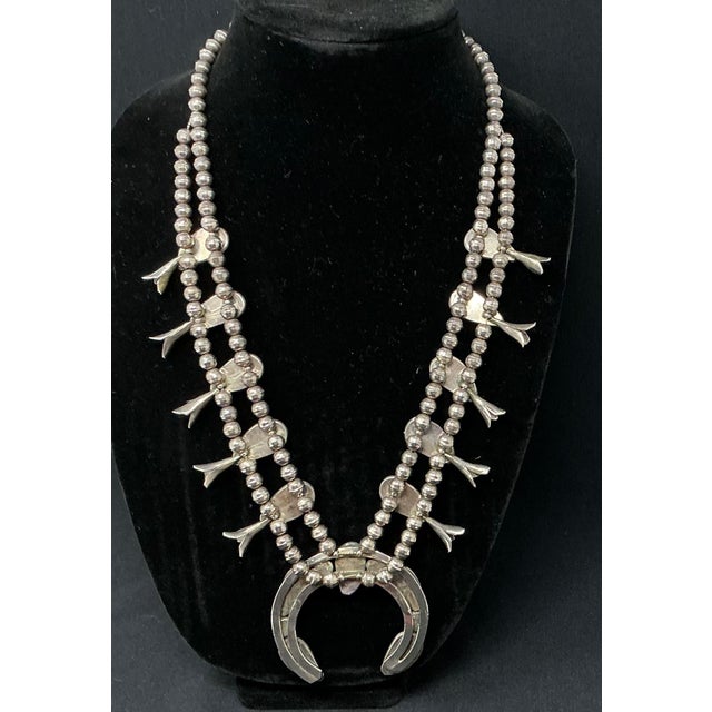 This necklace features a lovely crescent shaped naja (2.75” W x 2.5” L) highlighted with five coral cabochons resting in...