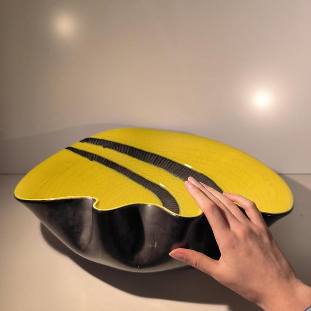 Large free-form, asymmetrical glazed ceramic bowl with a graphic decoration combining a bright yellow crackled glaze with...