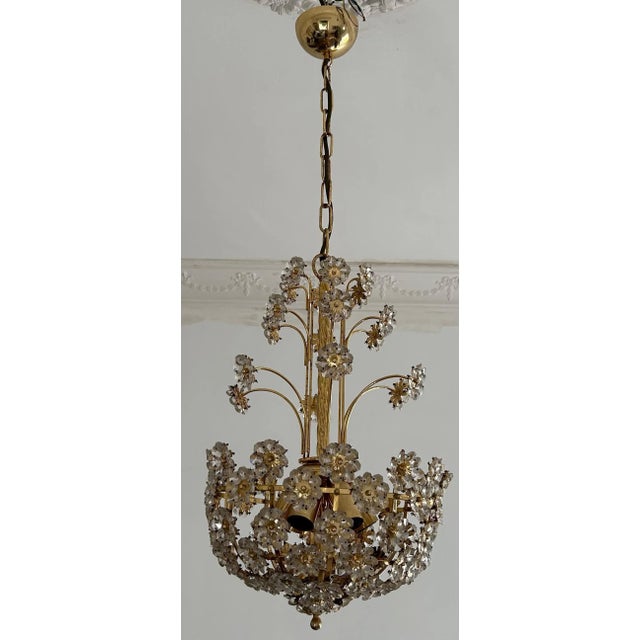 An elegant bouquet of shiny crystal flowers. Mesmerizing beauty reflecting light night and day. Total hight chain included...