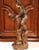 This tall antique terracotta sculpture depicts two expressive, young boys playing in rustic costume. The piece is signed...