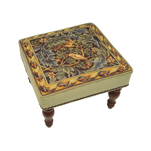 Meticulously handcrafted in the United Kingdom, this upholstered stool boasts classic studding and hand-polished solid...