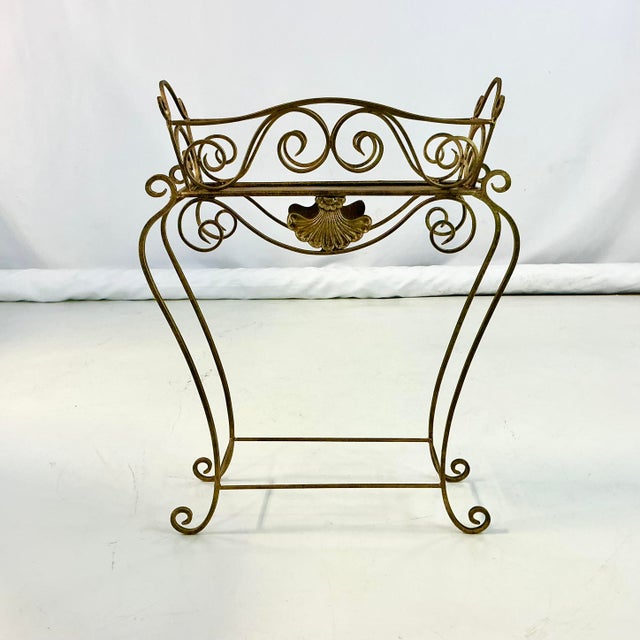This is a lovely vintage plant stand. It features a seashell front and center and its metal construction has detailed...