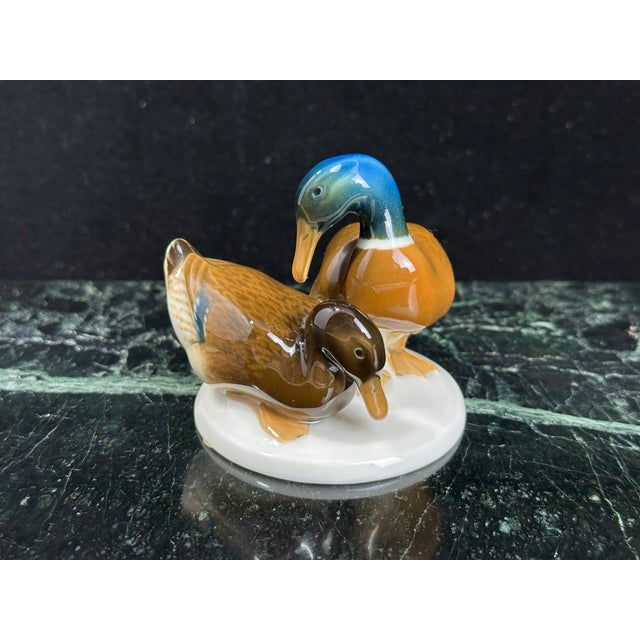 Hutschenreuther (Germany) hand-painted porcelain figurine of two adult mallard ducks and a duckling, with an iridescent...