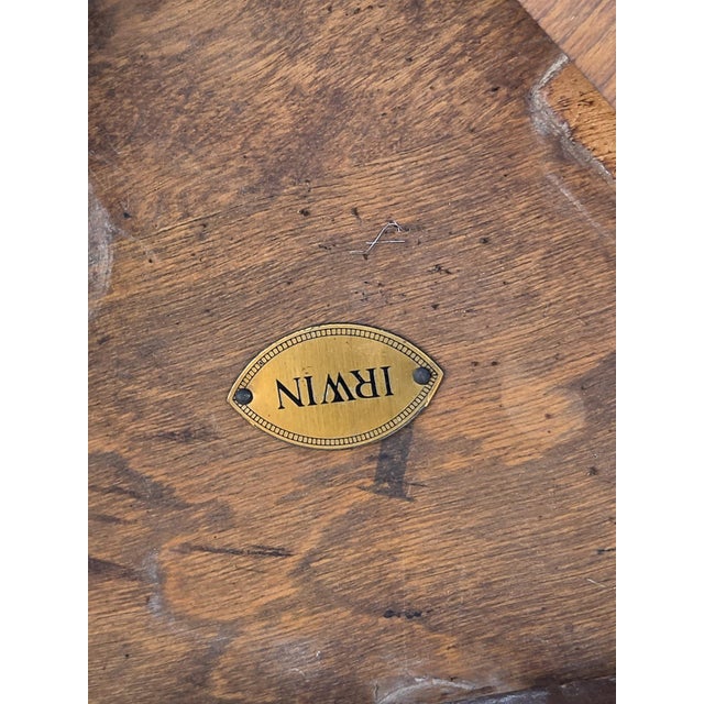 The product is a 21st Century French Empire Plum Mahogany Round Table, featuring intricate carvings and a shiny finish....