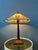 Large Tiffany style desk lamp with colourful stained glass shade. The base is made out of metal and the shade is made from...