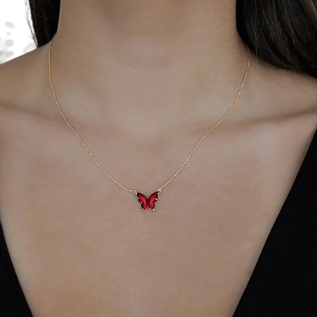The Gold Joy Red Enamel Butterfly Necklace, a captivating piece of jewelry that combines the beauty of sterling silver...