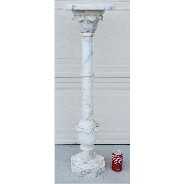 This exquisite antique italian Calcutta marble carved column pedestal display plant stand is a breathtaking piece of art...