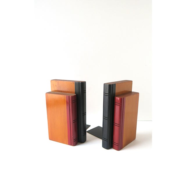 A pair of oak wood 'book' bookends, Midcentury Modern period, circa mid-20th century. Bookends are solid oak wood with red...