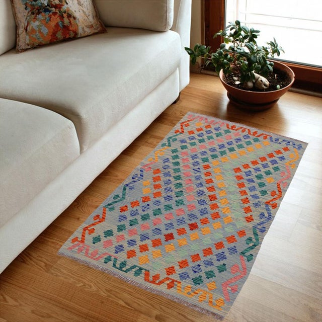 Add a touch of elegance to your home with this casual chic hand woven Tribal Kilim wool rug. Constructed on a loom by...