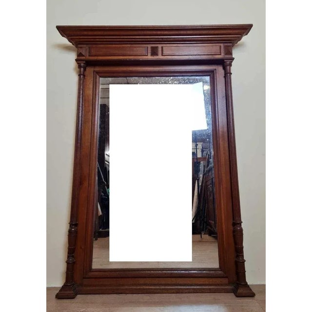 Large Renaissance style mirror in oak circa 1850 Topped with an ogee cornice Sides with fluted columns Beveled glass in a...