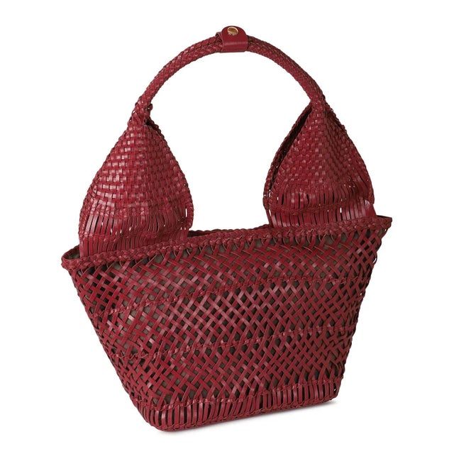 Woven wine leather tote. Lined with inside zipper pocket and magnetic snap closure.