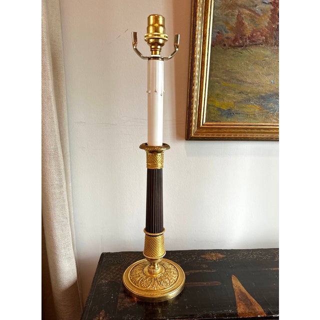 Single d'ore gilt bronze candlestick wired as a lamp. Mostly likely a period piece or near by in time, this candle stick...