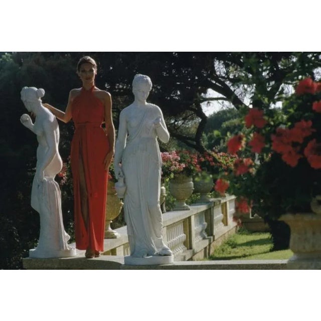 St Tropez Garden 1977 by Slim Aarons Slim Aarons Limited Estate Edition An elegant woman poses in a garden in St Tropez,...