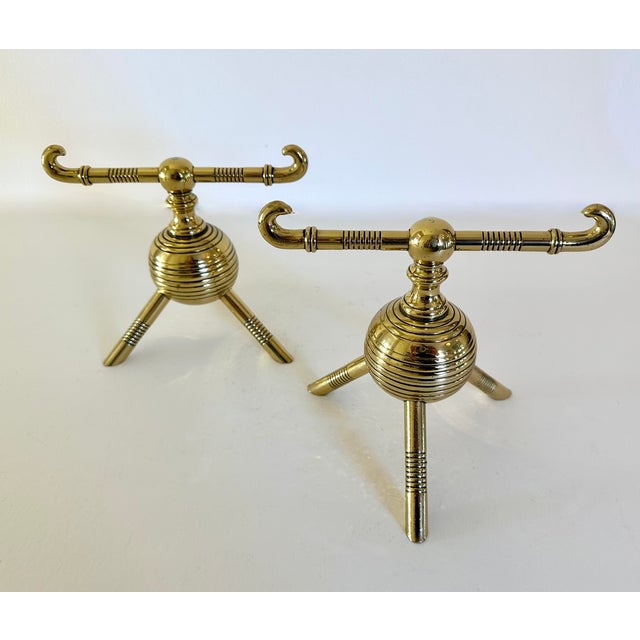 Pair of Aesthetic Movement firedogs or tool rests attributed to Christopher Dresser for Benham & Froud. Crafted in England...