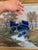 A hand-crafted stained glass fish sun catcher, designed with richly hued cobalt blue glass accented by swirled tonal...