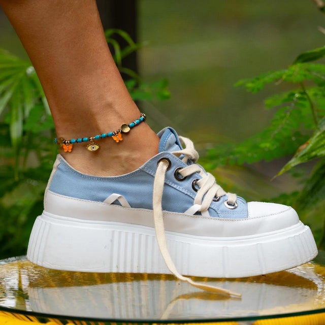 Bring a burst of joy and protection to your summer look with the Evil Eye & Butterfly Sunset Glow Beaded Anklet. This...