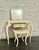 Cream-painted vanity table with matching bench and mirror, featuring sculptural curved legs and a soft,...
