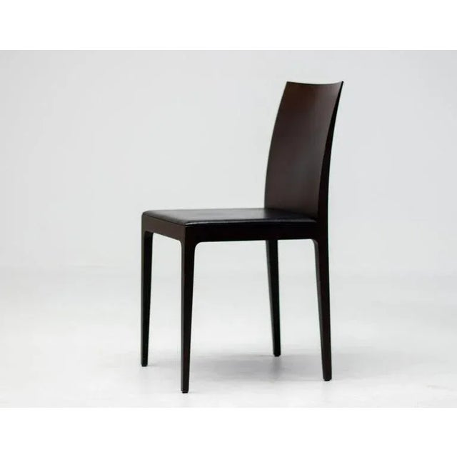 A set of six anna r dining chairs designed by ludovica and roberto palomba for crassevig. These chairs feature a dark...
