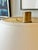 A matching pair of Ralph Lauren Modern table lamps featuring clear cylindrical glass bodies framed by natural brass bases...