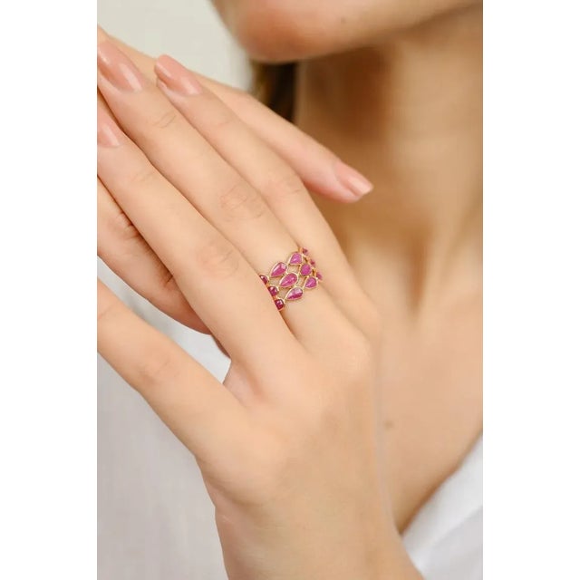 This is part of Chairish’s Fine Jewelry assortment. 6.33 Carat Natural Ruby Triple Row Band in 18K Gold symbolizes the...