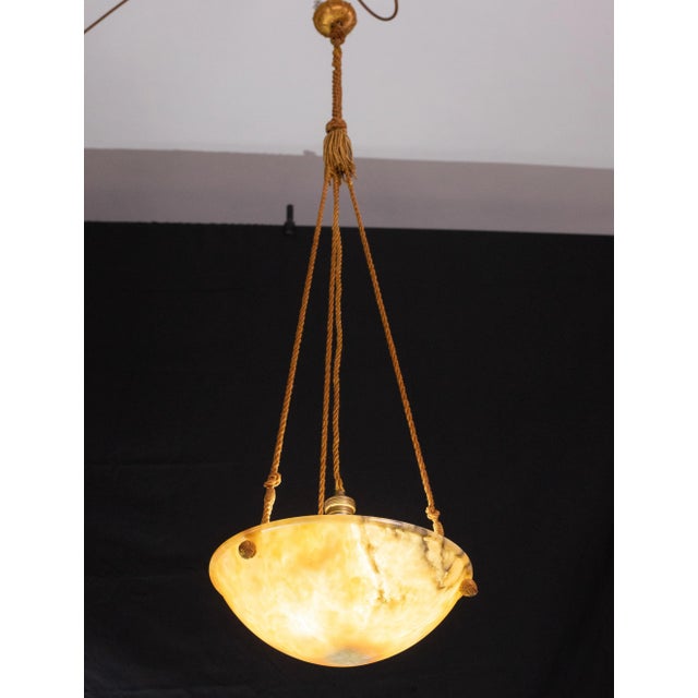 Antique orange alabaster hanging chandelier in Art Deco style, circa 1950s. A unique piece of orange alabaster,...