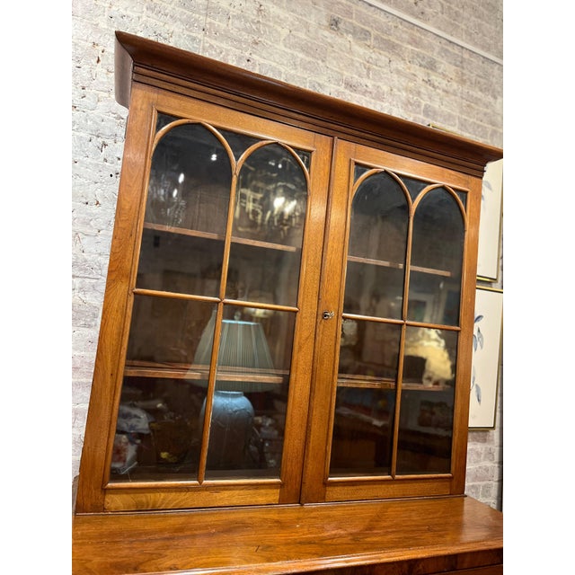 Handsome solid Walnut antique secretary. This exquisite late 1800s Empire-style secretary is crafted from rich walnut and...