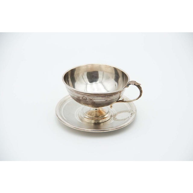 Embossed Teacup with Guilloche Silver Saucer, in Good conditions.