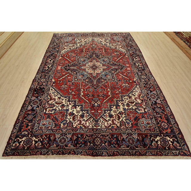 An authentic vintage traditional tribal Heriz rug, hand-knotted with fine wool and natural dyes. This rug features a...