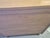 This is a Mid-Century Modern tallboy chest of drawers crafted from light-toned wood with a prominent natural grain. It...