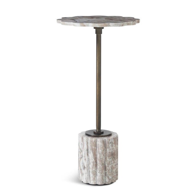 A subtle sculptural statement in stone and metal, this elegant end table pairs a beautifully scalloped marble top with a...