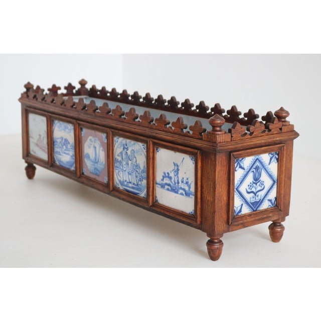 An exceptional and highly decorative pair of 19th-century dutch planters, masterfully crafted in hand-carved european oak...