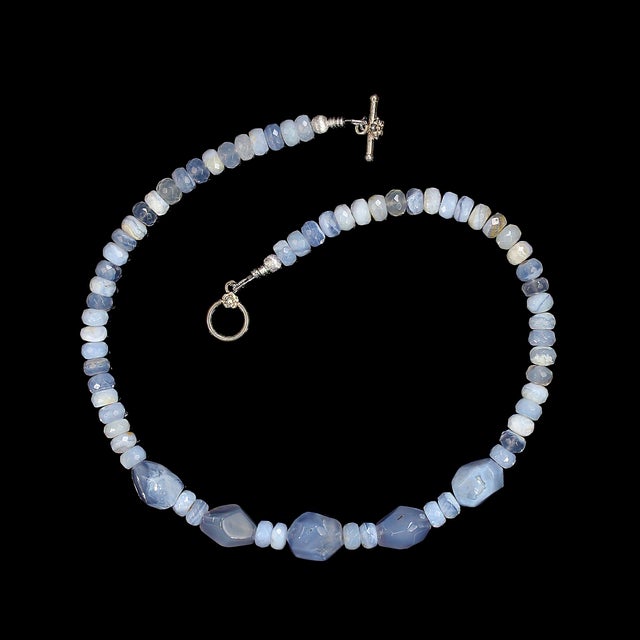 This elegant 17‑inch blue lace agate necklace brings a soft, serene beauty to any jewelry collection. The piece features a...