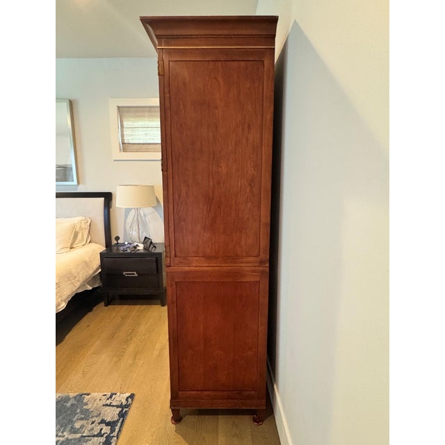 Vintage Baker Furniture mahogany armoire featuring beautifully figured wood panels, refined brass hardware and gold trim,...