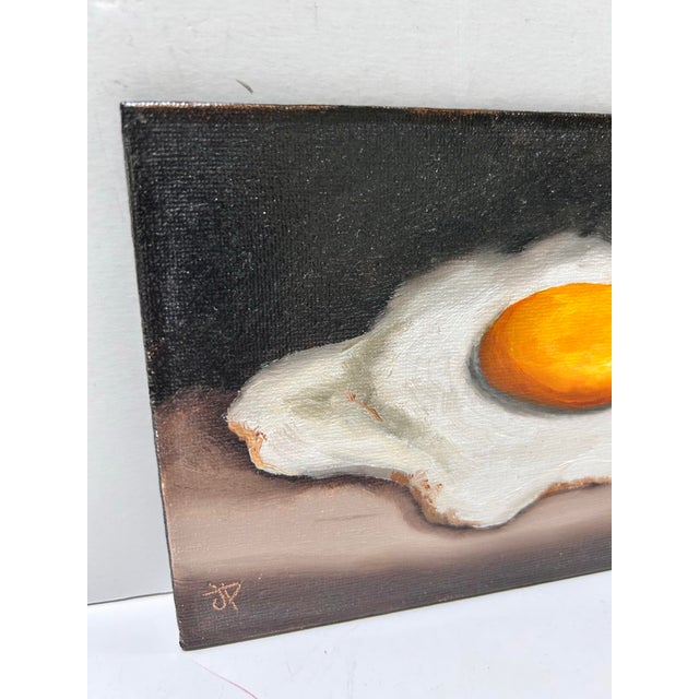 Original still life painting by Jane Palmer featuring a fried egg against a dark, moody background. The compact 5” x 7”...