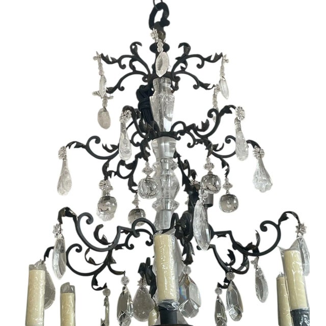 A magnificent and highly detailed twelve-light chandelier composed of hand-carved and polished rock crystal and hand-...