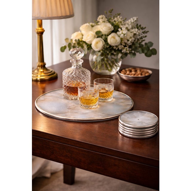 An elegant Art Deco set by Verlys France, comprising a trivet and four bottle coasters in molded opalescent glass,...