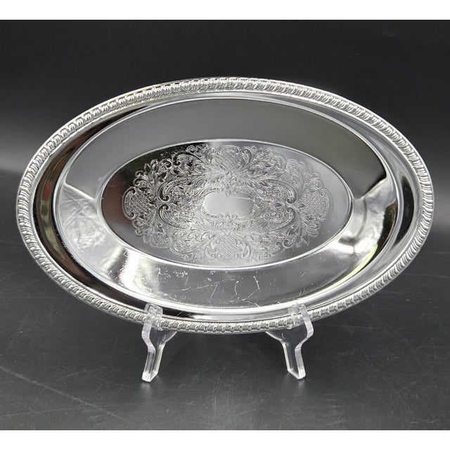 Vintage silver-plated oval serving tray. Manufactures style such as WM Rogers or Shelton Ware. Tray features detailed...