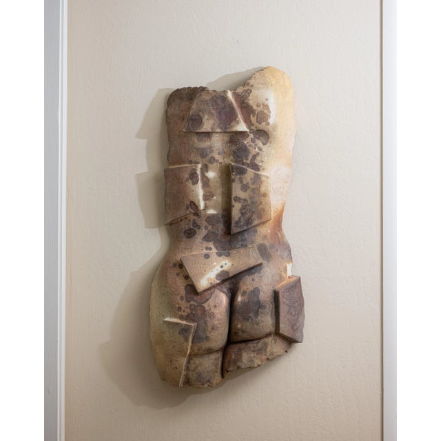 Dimensions: 33"H × 15"W × 5"D Handmade ceramic wall sculpture with an abstract geometric form reminiscent of a human...