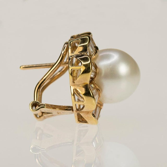 18k Earrings with two 12.1mm South Sea Pearls and 96 baguette diamonds weighing approximately 3.50 carats. 17.26 grams